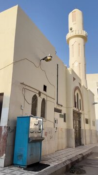 Street view of the historic Masjid Bani Haram exterior and outdoor ablution area in Medina.