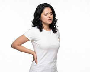Fototapeta premium Young Indian woman holding both hands on her lower back while experiencing moderate lumbar pain for physiotherapy chiropractic orthopedic healthcare and pain management