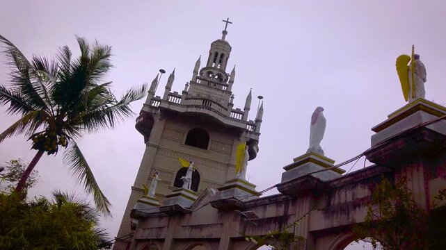 Simala Shrine - Cathedral Tower, Statues and Palm Trees - Catholic Church and Monastery of Holy Eucharist in Sibonga Village - Cebu City Region - Philippines Landmarks - Cloudy Day - LS MS 4K UHD