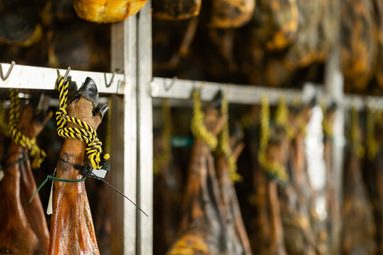 Process of making high quality ham from natural farm pork meat at the factory. Large batch of jamon is being prepared to be sent to the store