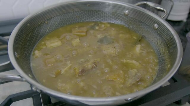 Filipino Lechon Paksiw cooking process in a kitchen