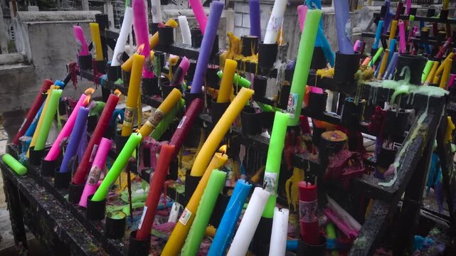 Simala Shrine - Burning Colourful Pray Candles - Catholic Church and Monastery of Holy Eucharist in Sibonga Village - Cebu City Region - Philippines Landmarks - Rainy Day - MS CU 4K UHD