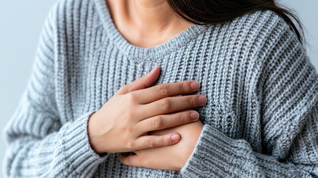 hand hold chest with heart attack symptoms, have chest pain caused by heart disease, leak, dilatation, enlarged coronary heart, press on the chest with a painful expression