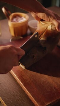 Close-up of slicing bamboo shoots on a wooden cutting board.
