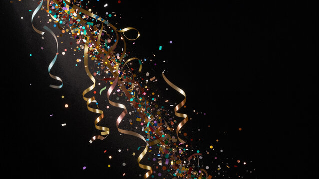 Festive explosion of golden streamers and colorful confetti on black background with copy space.