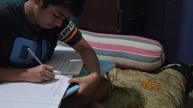 Young Student Studying at Home, Boy Writing Homework in Notebook at Desk, School Education and Learning Concept, Child Doing Schoolwork, Academic Preparation, Home Study and Student Lifestyle