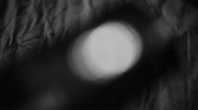 Dark abstract moody background with soft bokeh lights and fabric texture abstract background mysterious illumination material