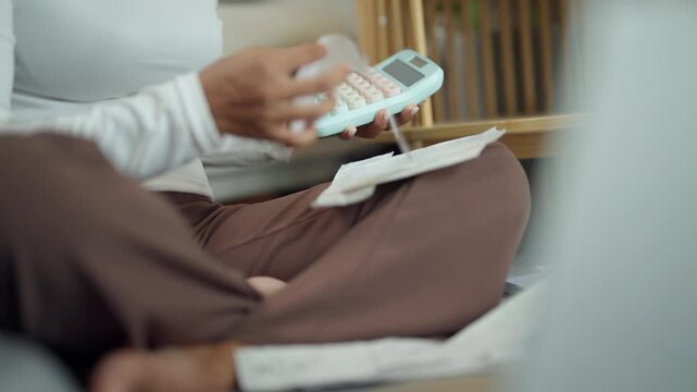Woman Reviewing Monthly Expenses and Calculating Personal Finances at Home