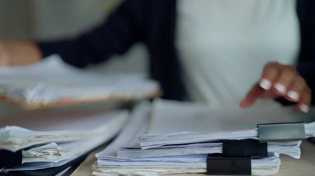 Businesswoman Sorting Paper Documents and Clipboard for Office Filing