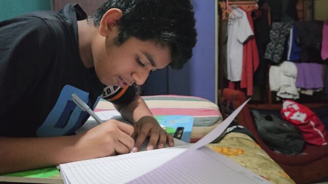 Young Student Studying at Home, Boy Writing Homework in Notebook at Desk, School Education and Learning Concept, Child Doing Schoolwork, Academic Preparation, Home Study and Student Lifestyle