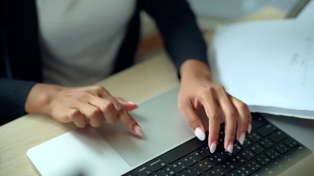 Businesswoman Using Laptop Touchpad While Working on Digital Project