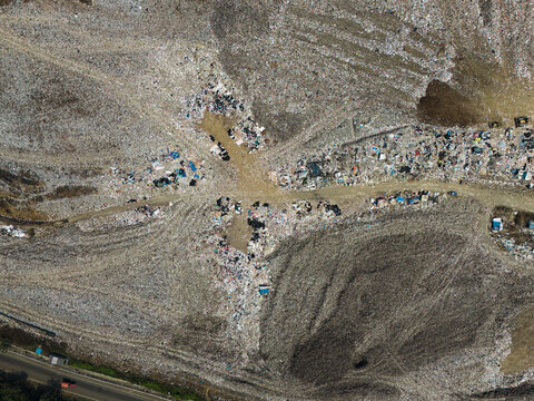 Aerial view of TPA Supit Urang, a modern sanitary landfill facility with waste processing areas and access roads in Malang, East Java, Indonesia.