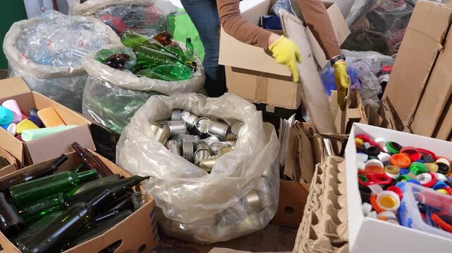 Waste recycling collection point with people sorting recyclables, eco friendly waste management, sustainability, environmental protection