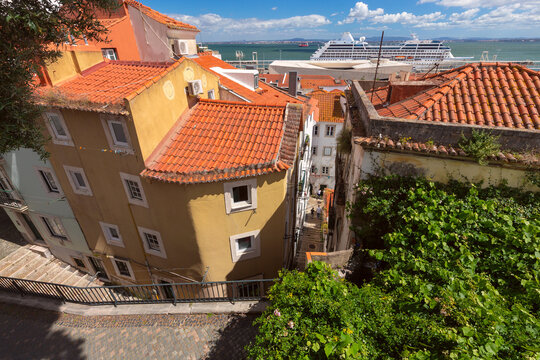 Alfama Rooftops and Cruise Ship Above the Tagus River in Lisbon, Portugal