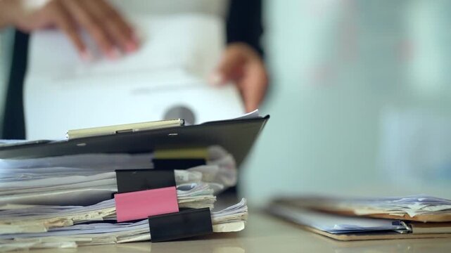 Stack of Business Documents and Paperwork on Office Desk