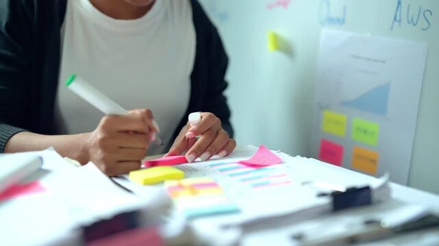 Businesswoman Analyzing Data and Planning Strategy with Sticky Notes
