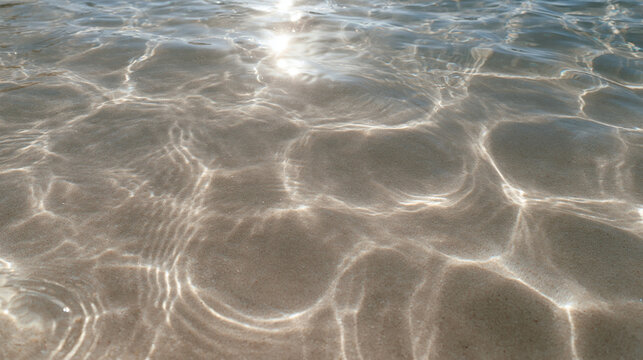 Sunlight Reflecting on Clear Shallow Water over Sandy Bottom