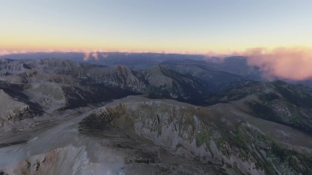 Circular aerial drone view at sunset of Pic de la Dona Mountain in Mantet. France