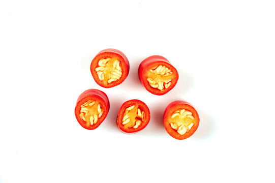 Fresh Red Chili Slices with Seeds on a White Background , Top view