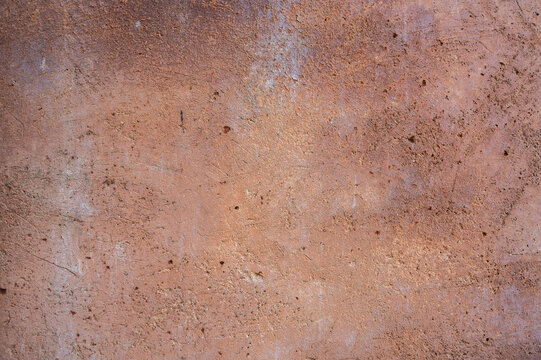 Full frame shot of an earthen wall texture of clay house structure. These walls are constructed by ramming a mixture of aggregates, including gravel, sand, silt and a small amount of clay.