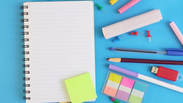 Stationery items spread over blue background