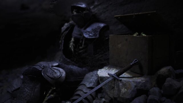 Armored knight slumped beside chest, moonlit cavern strewn with coins, broken spear and scattered rubble, cinematic lowkey lighting and moody atmosphere
