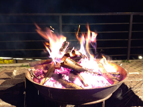Fire Pit With Bright Flames and White Hot Ash at Night