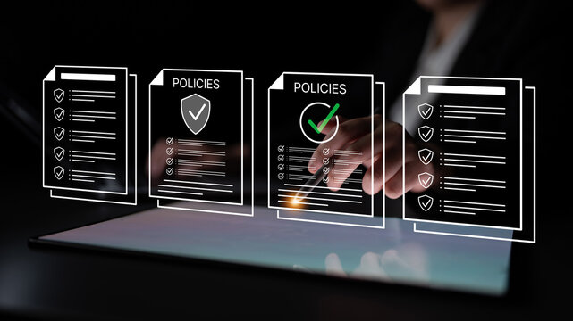 Business professional reviewing documents on a digital tablet with policy guidelines and approval process in a modern office setting. Bitwise.