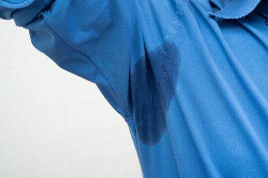 Man with sweaty arm pit on shirt when working in office, Hyperhidrosis sweating.