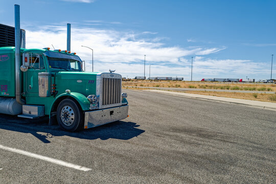Bliss, Idaho, USA - July 3, 2026: The front of a green Peterbilt semi truck parked at a rest stop on Interstate 86