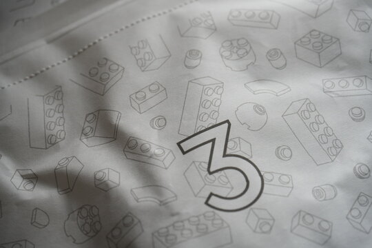 A paper bag printed with toy building block illustrations.