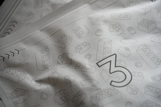 A paper bag printed with toy building block illustrations.