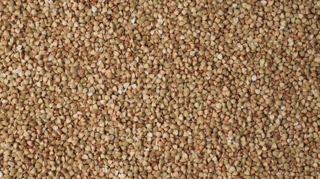 Raw buckwheat groats grains background texture