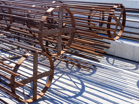 Reinforced concrete construction. Steel reinforcement cages prepared for foundation and column installation, supporting structural concrete work and civil engineering projects.