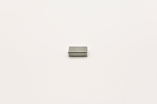 Small rectangular metallic object on a white background