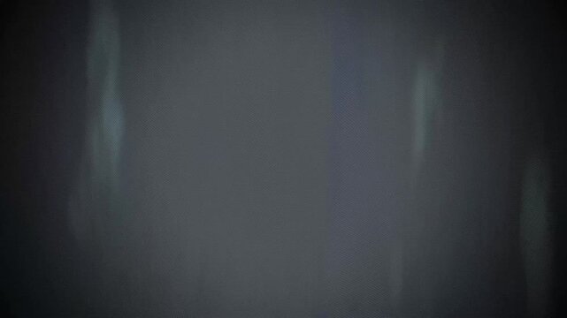 Abstract dark metallic texture surface background with shifting light reflections loop