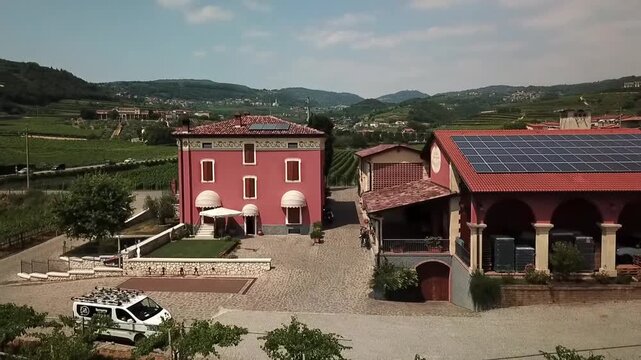 Historic Veneto wine estate with solar-powered barn, surrounded by terraced vineyards near Italy's UNESCO Prosecco hills