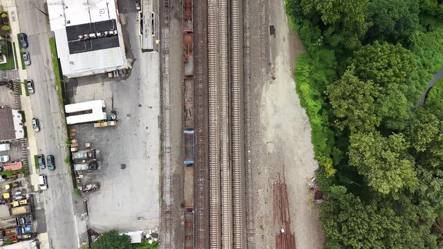 Top-down drone view of a freight train on an urban rail corridor in Mount Vernon, New York