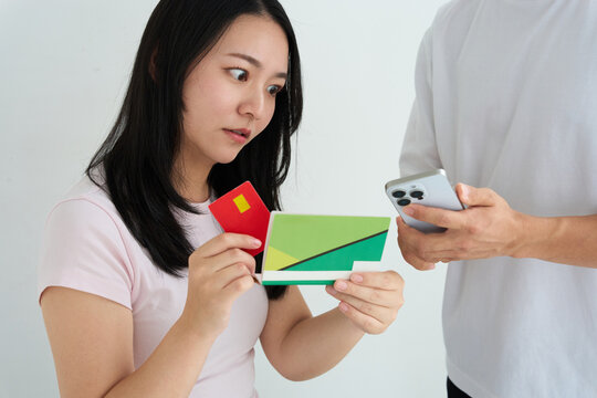 Young Japanese Couple Holding Bankbook and Credit Card at Home
