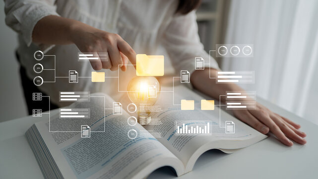 A reader engages with a book while interacting with digital data visualization. This image highlights the blend of traditional learning and modern technology in education. Gantry