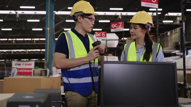 Team of Asian warehouse retail workers in uniform with yellow safety helmets standing, talking, testing, preparing and ready to work at their assigned product inspection points in distribution center.