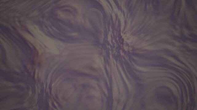 Abstract purple liquid water ripples moving in slow motion for background