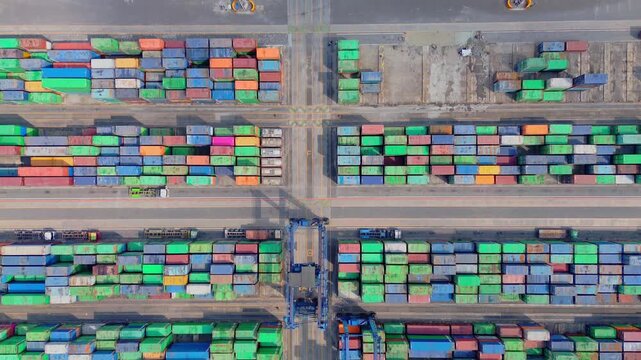 Aerial view of TPK Palaran container terminal with rows of colorful shipping containers and gantry cranes in Samarinda, East Kalimantan, Indonesia.