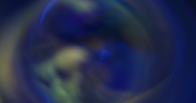Blur kaleidoscope flare. Blue light abstraction. Purple neon yellow colorful optical gleam circle on luminous bokeh glisten art background.