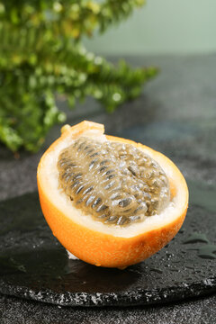 Fresh Golden Passion Fruit Half with Seeds on Slate Stone - Tropical Sweet Fruit from Yunnan