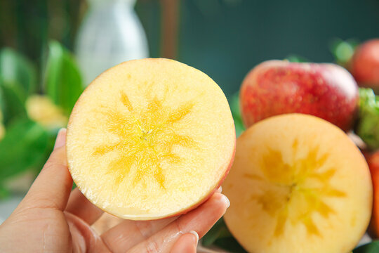 Fresh Apple Slice with Star Core Pattern Held in Hand - Healthy Organic Fruit Concept