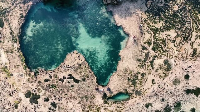 Aerial view of the natural rock formation shaped like the African continent surrounded by turquoise water in Kwale, Kwale County, Kenya.