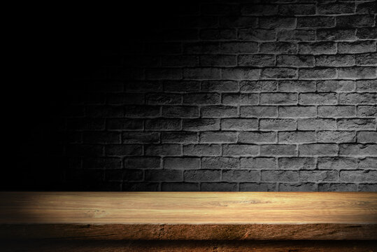 Wooden table in dark room background concept for advertising