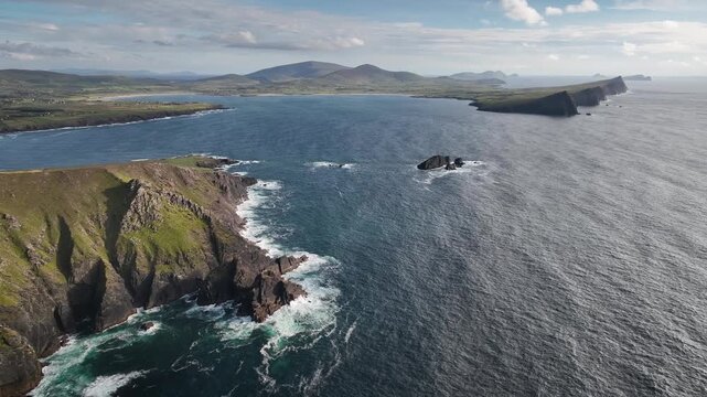 Aerial footage of rocky cliffs, coastal headlands, the Three Sisters and views across the Atlantic Ocean. Dun Mor&aacute;in coastline and Three Sisters on the Dingle Peninsula, County Kerry, Ireland. 