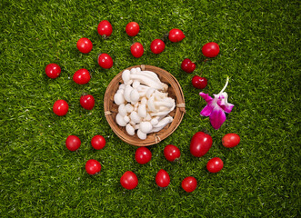 Fresh White Mushrooms and Cherry Tomatoes on Green Grass - Organic Vegetables and Healthy Food Ingredients © NguyenVan